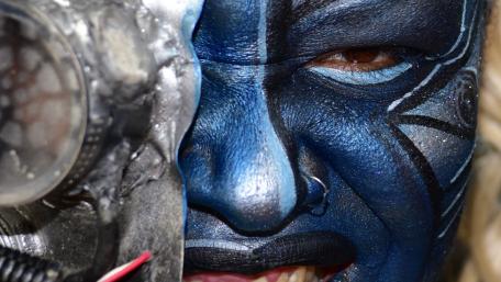 Mystical Warrior with Stunning Face Paint and Gear wallpaper