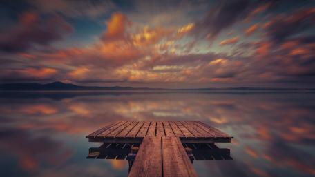 Pier reflectedin a lake wallpaper