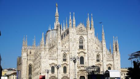 Gothic Splendor of Milan Cathedral in Bright Blue Sky wallpaper