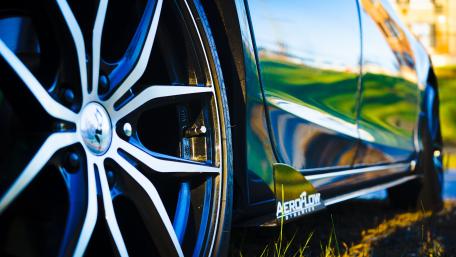 Sleek Low Angle View of Alloy Wheel and Tire wallpaper