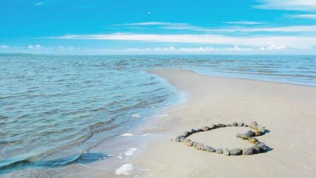 Heart of stones on the beach wallpaper