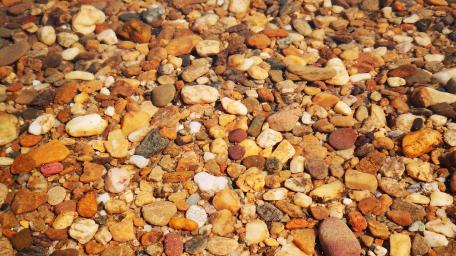 Colorful Pebbles Under Water Surface wallpaper