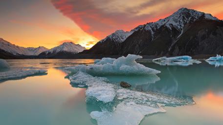 Majestic Frozen Mountain Reflections in Orange Sky wallpaper