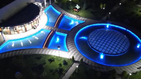 Stunning Nighttime Cityscape with Illuminated Water Features wallpaper