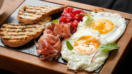 Delicious Breakfast Spread with Fried Eggs and Toast wallpaper