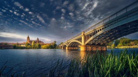 Bridge Over Tranquil Waters in a Cityscape Scene wallpaper