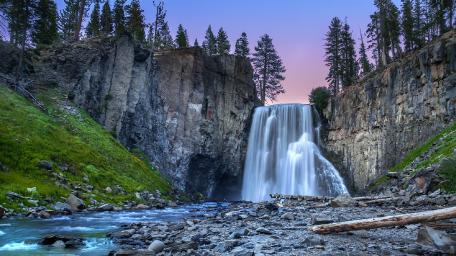 Majestic Waterfall in a Serene Landscape wallpaper