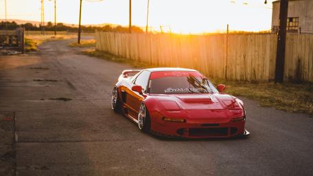 Sunset Drive with Sleek Red Acura Sports Car wallpaper