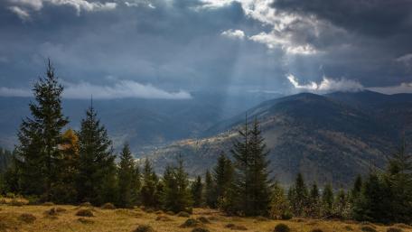 Majestic Mountain Landscape Under Dramatic Clouds wallpaper