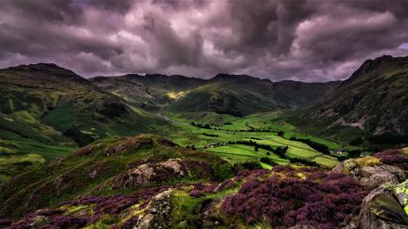 Dramatic Hills Under Cloudy Skies wallpaper