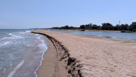Serene Beach Shoreline Under Clear Blue Sky wallpaper