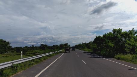 Serene Road Under Cloudy Skies wallpaper