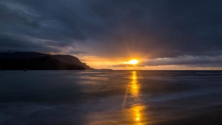 Golden Sunset Rays Break Through Stormy Skies wallpaper
