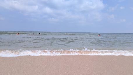 Serene Beach Waves Under a Blue Sky wallpaper