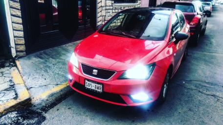 Sleek Red Car on Urban Streets wallpaper