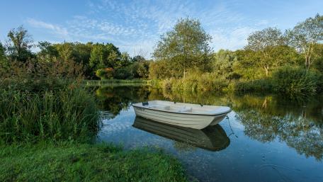 Boat on a fishing lake wallpaper