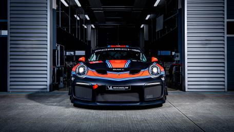 Sleek Porsche Race Car in the Garage wallpaper