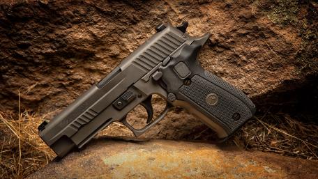 Military Pistol on Rustic Stone Surface wallpaper