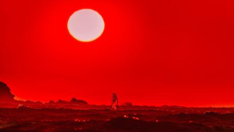 Fiery Sunset Over Windsurfing Adventure wallpaper