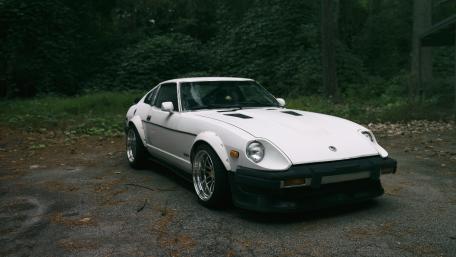 Classic Dream Car in a Forest Setting wallpaper