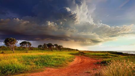 Dramatic Skies Over Serene Landscape wallpaper
