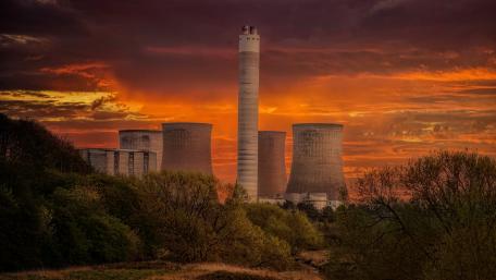 Industrial sunset against a vibrant sky and cooling towers wallpaper