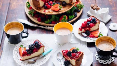 Delightful Dessert Spread with Fresh Berries and Coffee Treats wallpaper