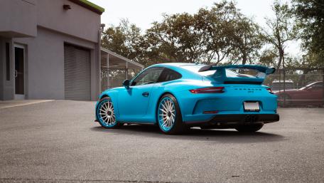 Sleek Blue Sports Car in Urban Setting wallpaper