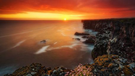 Burning Sunset Over Rugged Coastline wallpaper