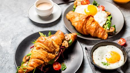 Delicious Breakfast Spread with Croissant and Eggs wallpaper