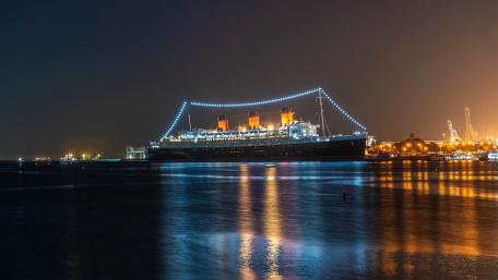 Majestic Ship Illuminated Against Night Sky for Wallpaper wallpaper