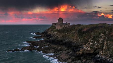 Sunset Fortress on the Rocky Coast wallpaper