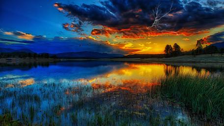 Striking Sunset Over Tranquil Lake wallpaper