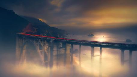 Mysterious Bridge Amidst Dreamy Foggy Landscape wallpaper