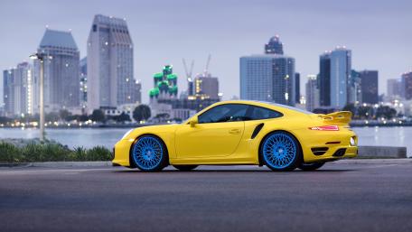 Yellow Porsche by the City Skyline wallpaper