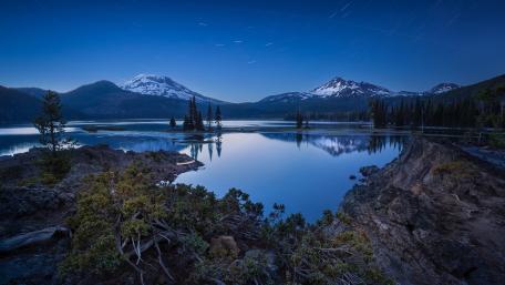 Twilight Reflections and Star Trails Over Lake wallpaper