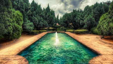 Peaceful Garden Oasis with Fountain and Pool wallpaper