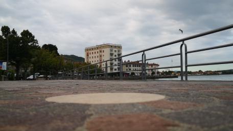 Serene Waterfront Walkway Beneath Clouds wallpaper