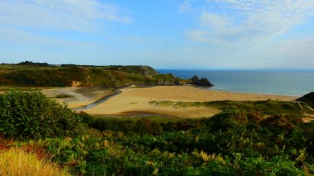 Serene Coastal Landscape with Clear Blue Skies wallpaper