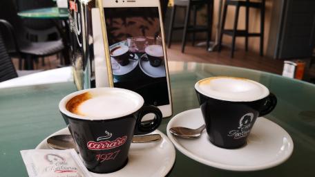 Coffee Conversations Over Elegant Cappuccinos wallpaper