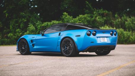 Sleek Blue Corvette in a Serene Setting wallpaper