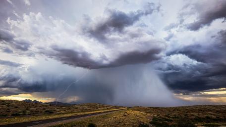 Dramatic Thunderstorm Over Open Landscape wallpaper