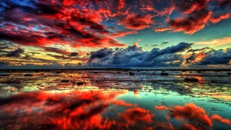 Fiery Sunset Over Tranquil Waters wallpaper