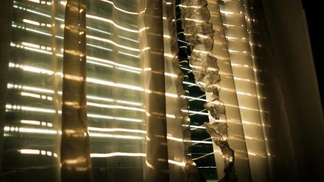Golden Sunlight Streaming Through Curtains wallpaper