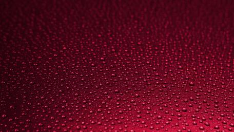 Red Waterdrops on Smooth Surface in 4K Quality wallpaper