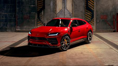 Sleek Red Sports Car in Industrial Setting wallpaper
