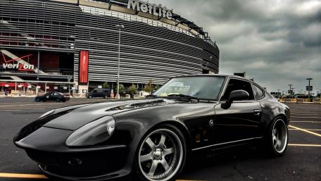 Celebrating Speed and Style in a Vintage Car Scene wallpaper