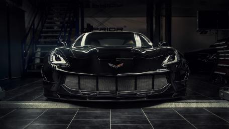 Sleek Black Corvette in Garage wallpaper