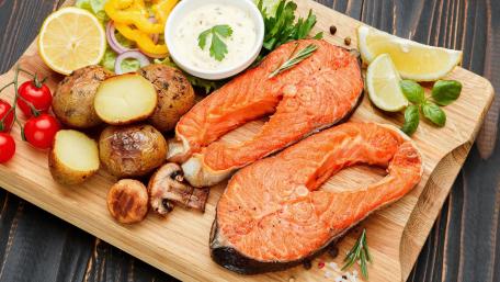 Delicious Salmon and Potatoes on a Wooden Board wallpaper