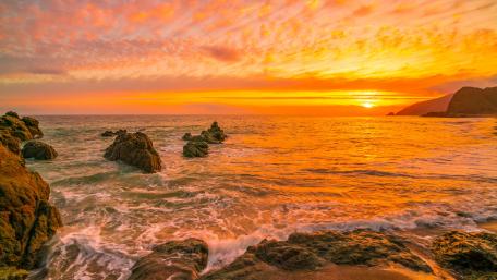 Burning Sunset Over Tranquil Shore wallpaper